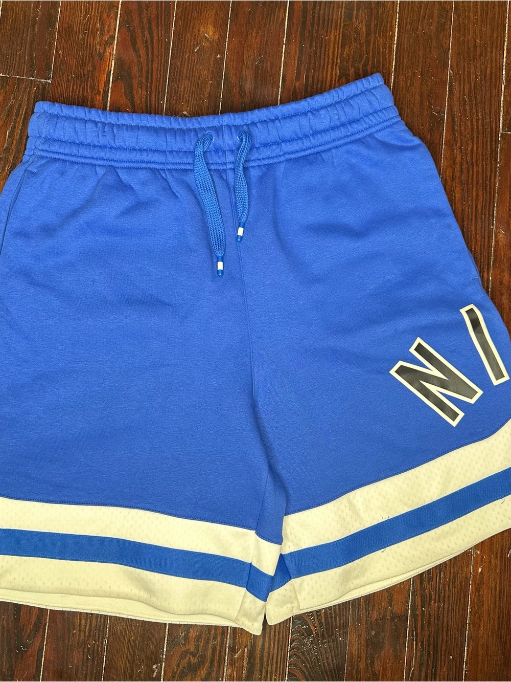 Nike Blue Athletic Shorts with Cream Contrast Stripes